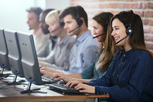 Line of callcenter agents in front of computers